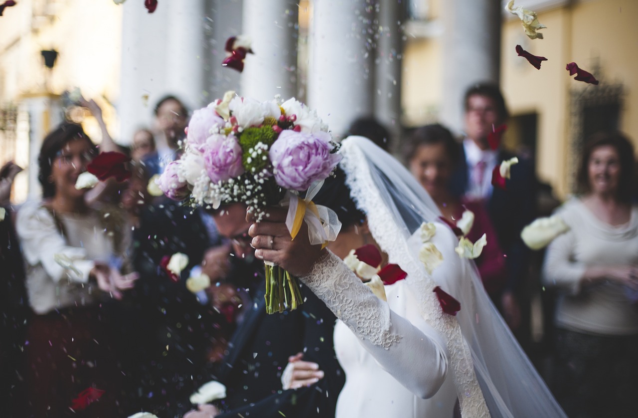 Elegant wedding decor with fairy lights and floral centerpieces Bride and groom walking down